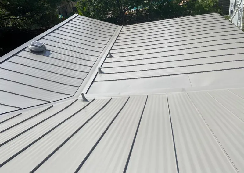 Solar attic fan installed on a metal roof for Roof Ventilation in Columbia Heights